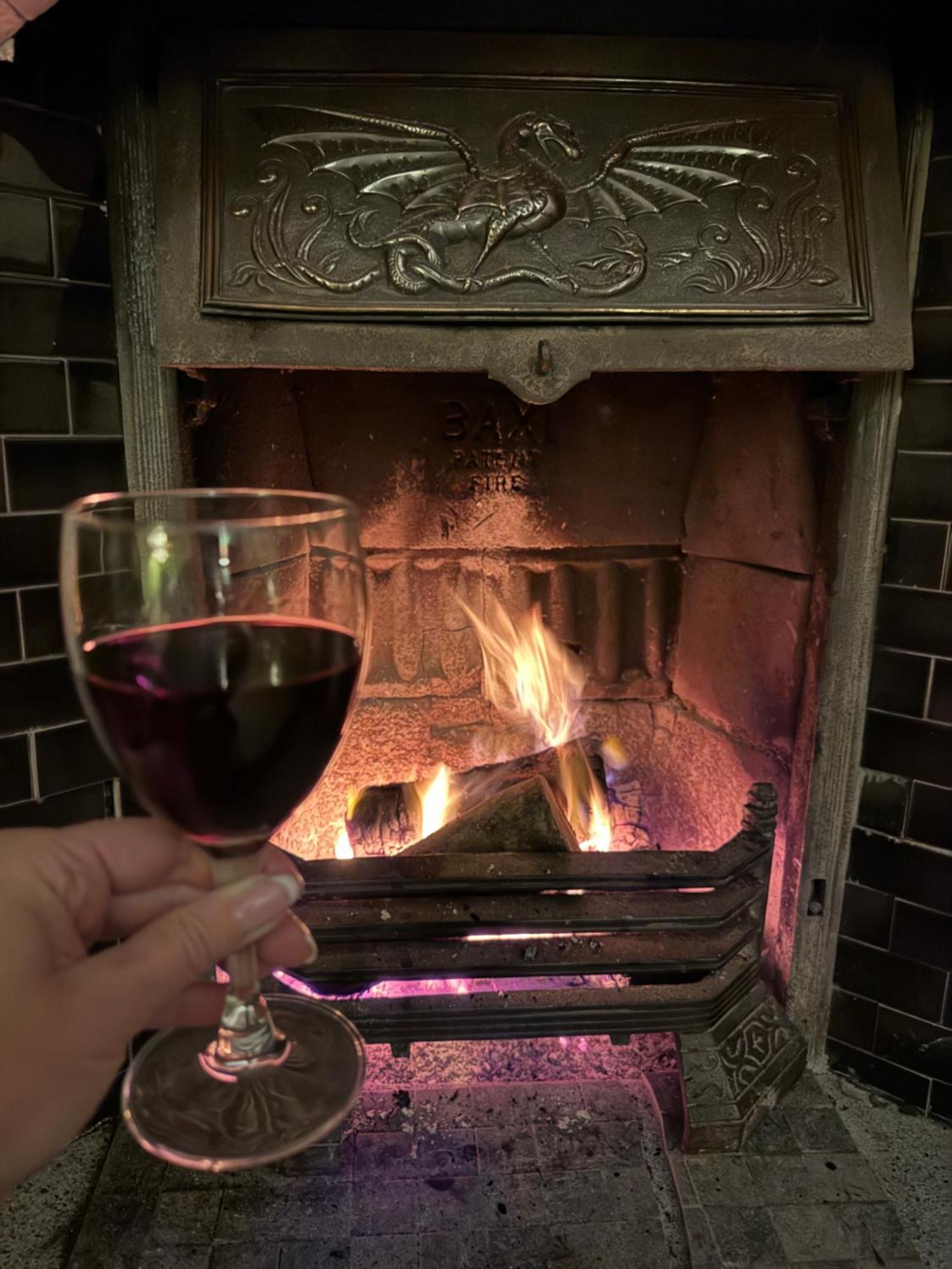 Clone Country House Aughrim Exteriör bild A glass of red wine in front of a fireplace